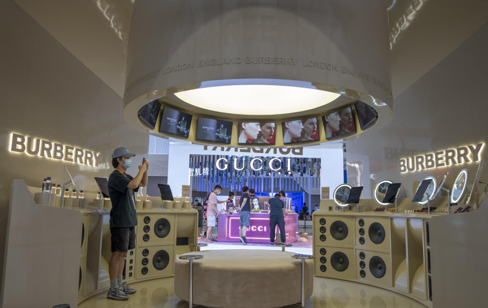 An exhibitor works at Burberry booth before the 2nd China International Consumer Products Expo at the Hainan International Convention and Exhibition Center. - Credit: VCG via Getty Images