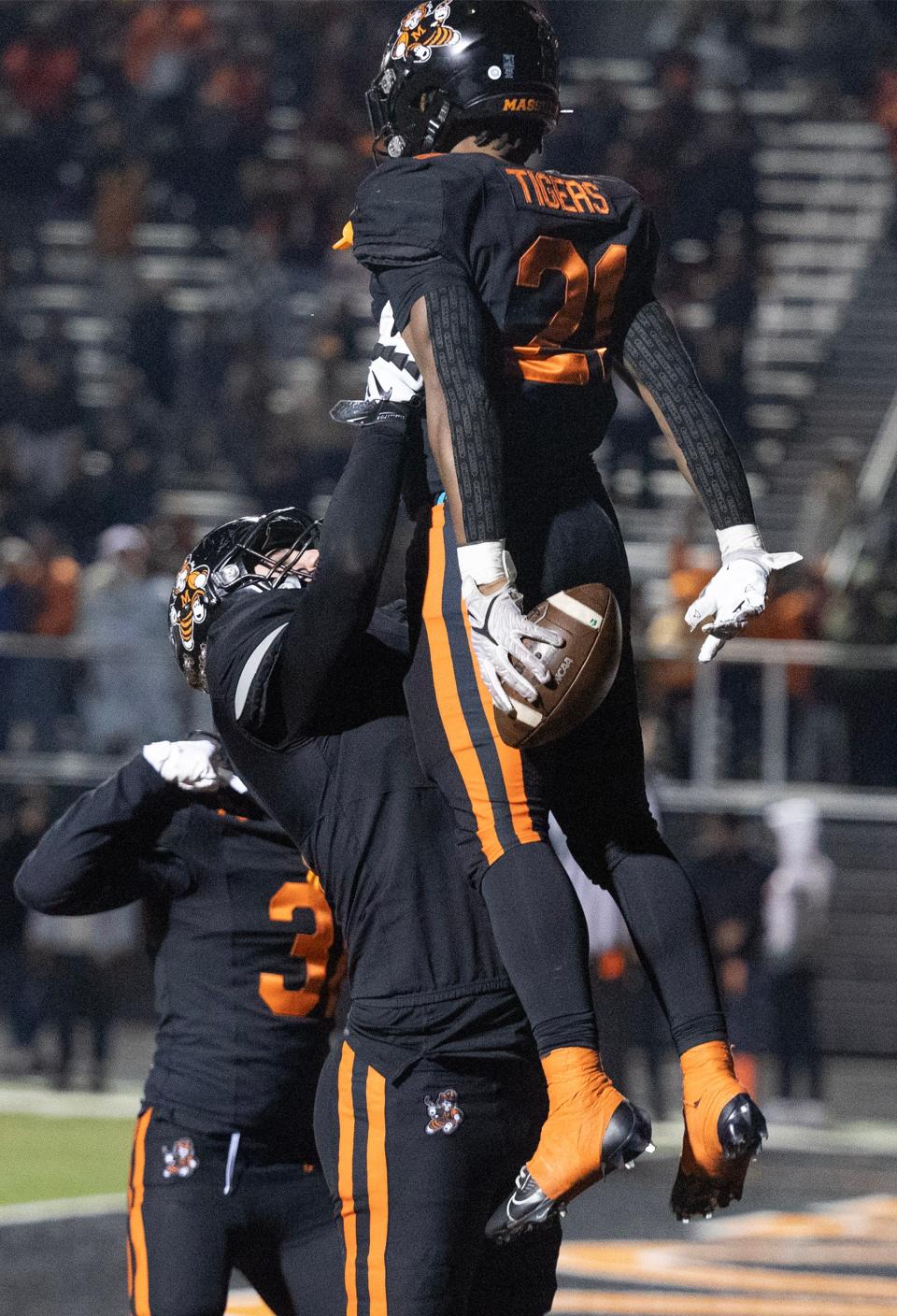 Massillon's Ja'Meir Gamble is lifted up by lineman Nolan Davenport after a second-half touchdown in their OHSAA Div. II regional semifinal vs. Lake at Hoover High School Friday, Nov. 10, 2023.