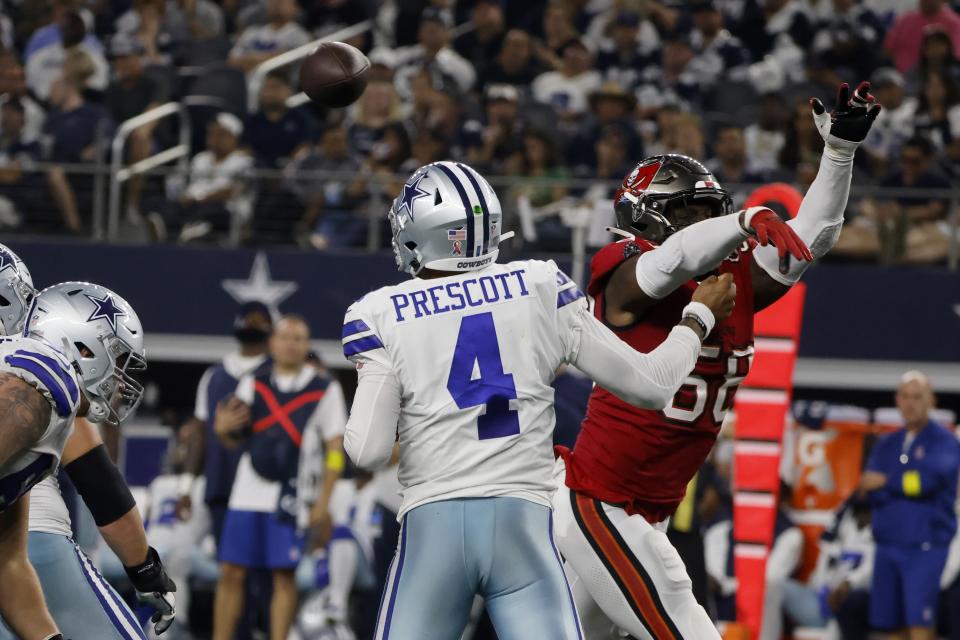 Dallas Cowboys quarterback Dak Prescott (4) is hit by Tampa Bay Buccaneers linebacker Shaquil Barrett (58) after throwing a pass in the second half of a NFL football game in Arlington, Texas, Sunday, Sept. 11, 2022. (AP Photo/Michael Ainsworth)