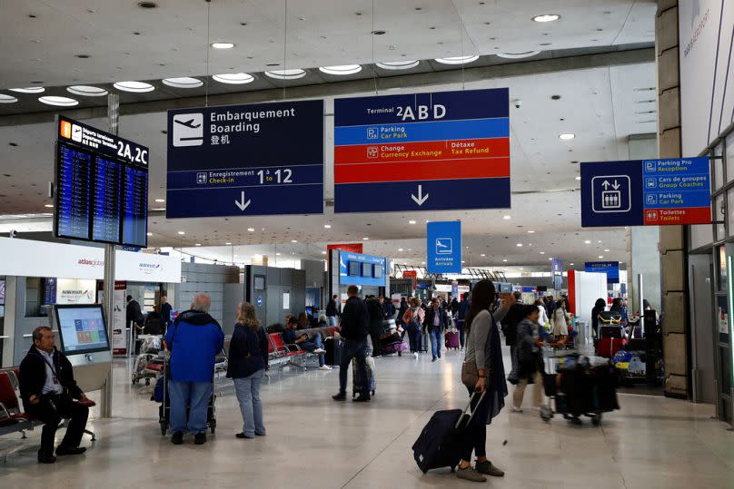 Passengers wait in the arrivals hall of Paris Charles de Gaulle airport, in Roissy, near Paris - could future travellers face disruption?