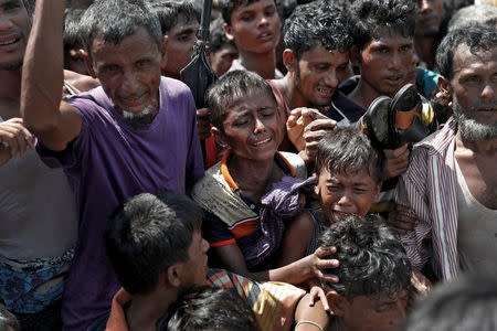 Boys react as Rohingya refugees scuffle in a queue for aid at Cox's Bazar, Bangladesh, September 26, 2017. REUTERS/Cathal McNaughton