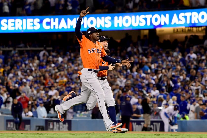 LOS ANGELES, CA - NOVEMBER 01: Cameron Maybin #3 and George Springer #4 of the Houston Astros celebrate after defeating the Los Angeles Dodgers 5-1 in game seven to win the 2017 World Series at Dodger Stadium on November 1, 2017 in Los Angeles, California. (Photo by Harry How/Getty Images)