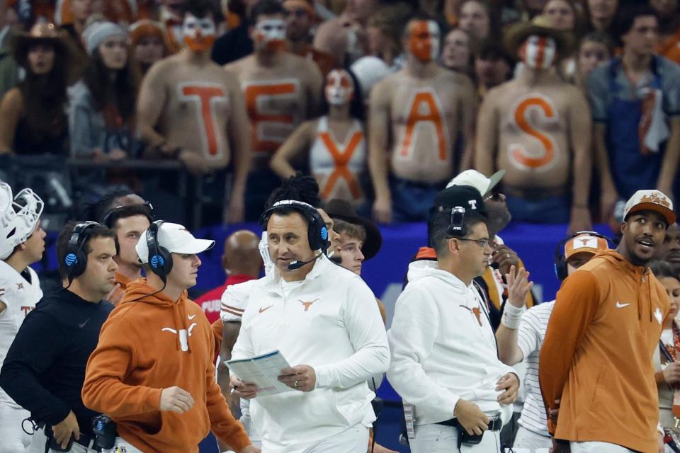 Coach Steve Sarkisan walks the sideline during Texas' CFP semifinal loss to Washington. That's the last time we've seen the Longhorns in action, but they will return to the field for spring practices Tuesday. The Orange-White game will be April 20.