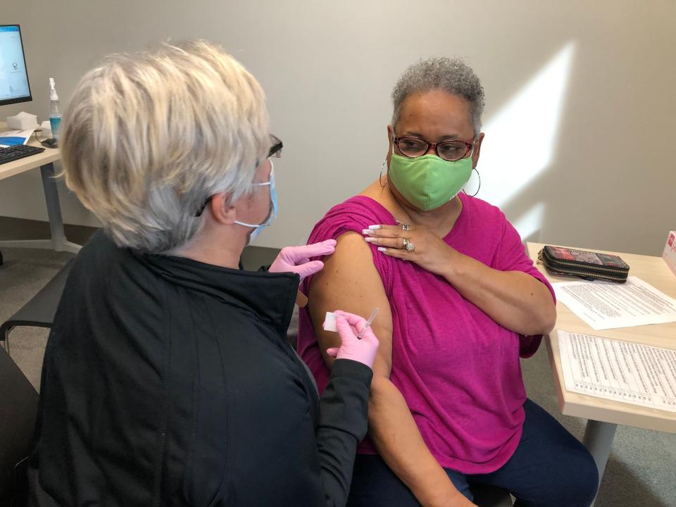 Krista MacArthur administers a COVID-19 vaccine to Theresa Hansbrough on Monday at the YMCA in West Louisville, Ky. Hansbrough was among those people over 70 who scheduled an appointment for the limited amounts of vaccine.