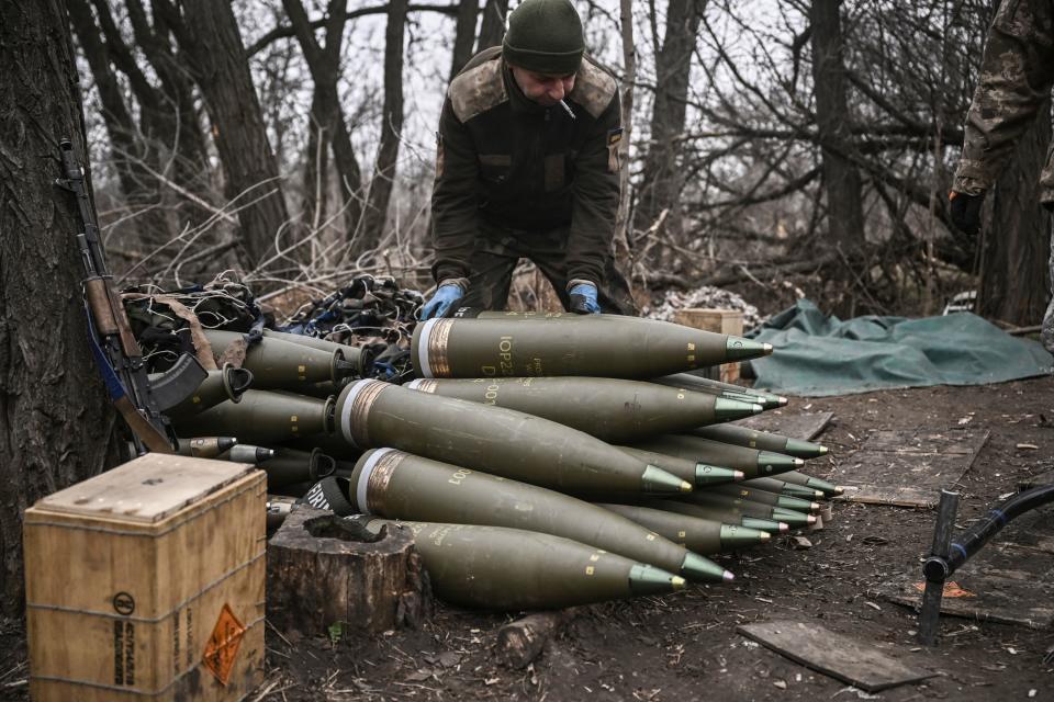 A Ukrainian serviceman prepares 155 mm artillery shells.