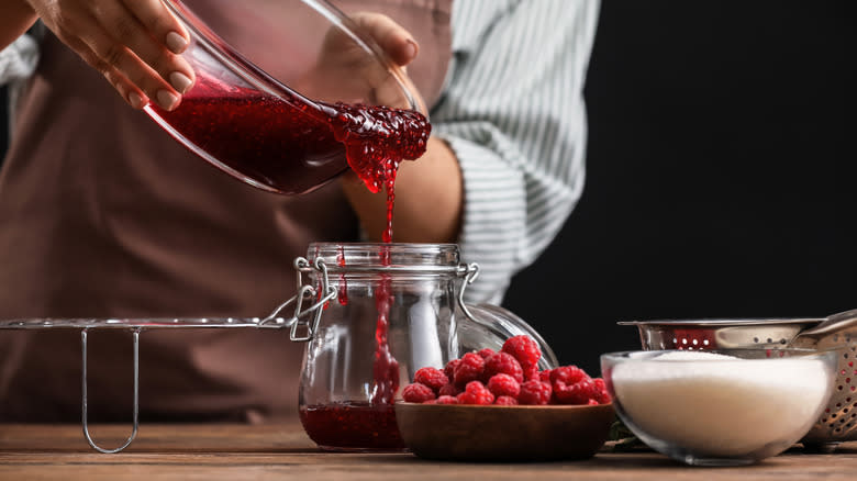 filling a jar with jam