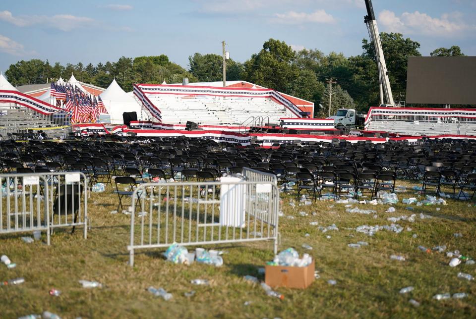 The scene of the Trump assassination attempt in Butler, Pennsylvania, shows empty bleachers, seats, and a stage, surrounded by litter.