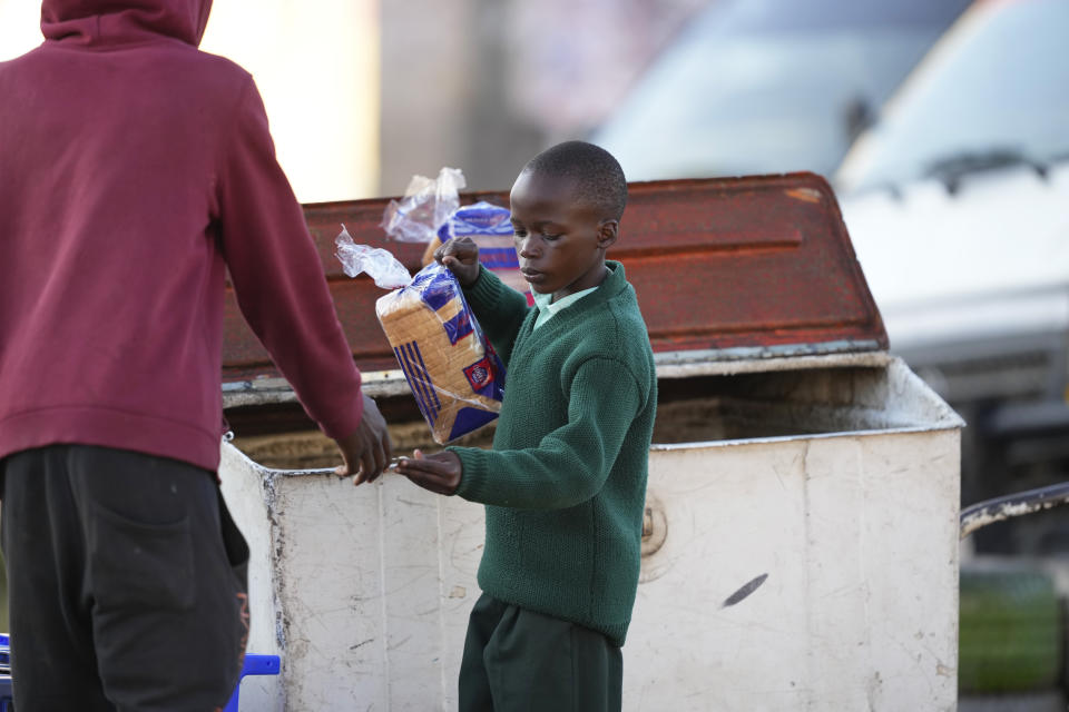 A young boy buys a loaf of bread from a street vendor in Harare, Zimbabwe, Monday, May, 23, 2022. Rampant inflation is making it increasingly difficult for people in Zimbabwe to make ends meet. Since the start of Russia’s war in Ukraine, official statistics show that Zimbabwe’s inflation rate has shot up from 66% to more than 130%. The country's finance minister says the impact of the Ukraine war is heaping problems on the already fragile economy. (AP Photo/Tsvangirayi Mukwazhi)