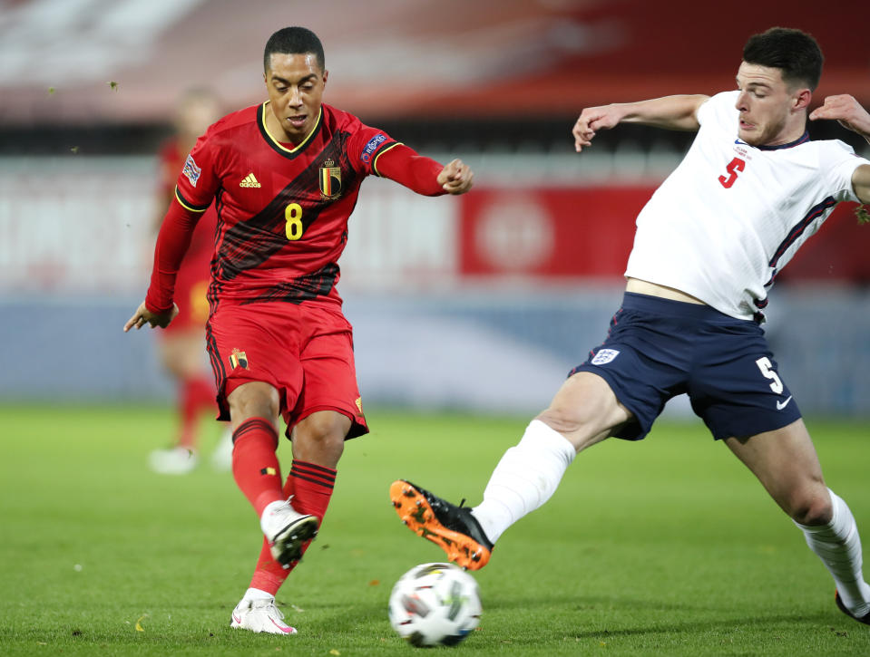 Belgium's Youri Tielemans, left, kicks the ball past England's Declan Rice to score his team's first goal during the UEFA Nations League soccer match between Belgium and England at the King Power stadium in Leuven, Belgium, Sunday, Nov. 15, 2020. (AP Photo/Francisco Seco)