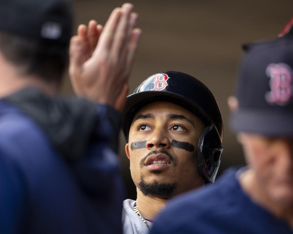 Boson Red Sox's Mookie Betts is congratulated by teammates after scoring against the Minnesota Twins in the first inning of a baseball game Monday, June 17, 2019, in Minneapolis. (AP Photo/Andy Clayton- King)