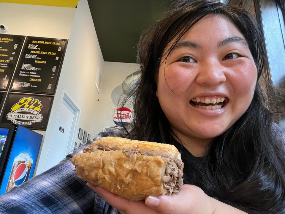 The author smiling and holding an Al's Beef sandwich.