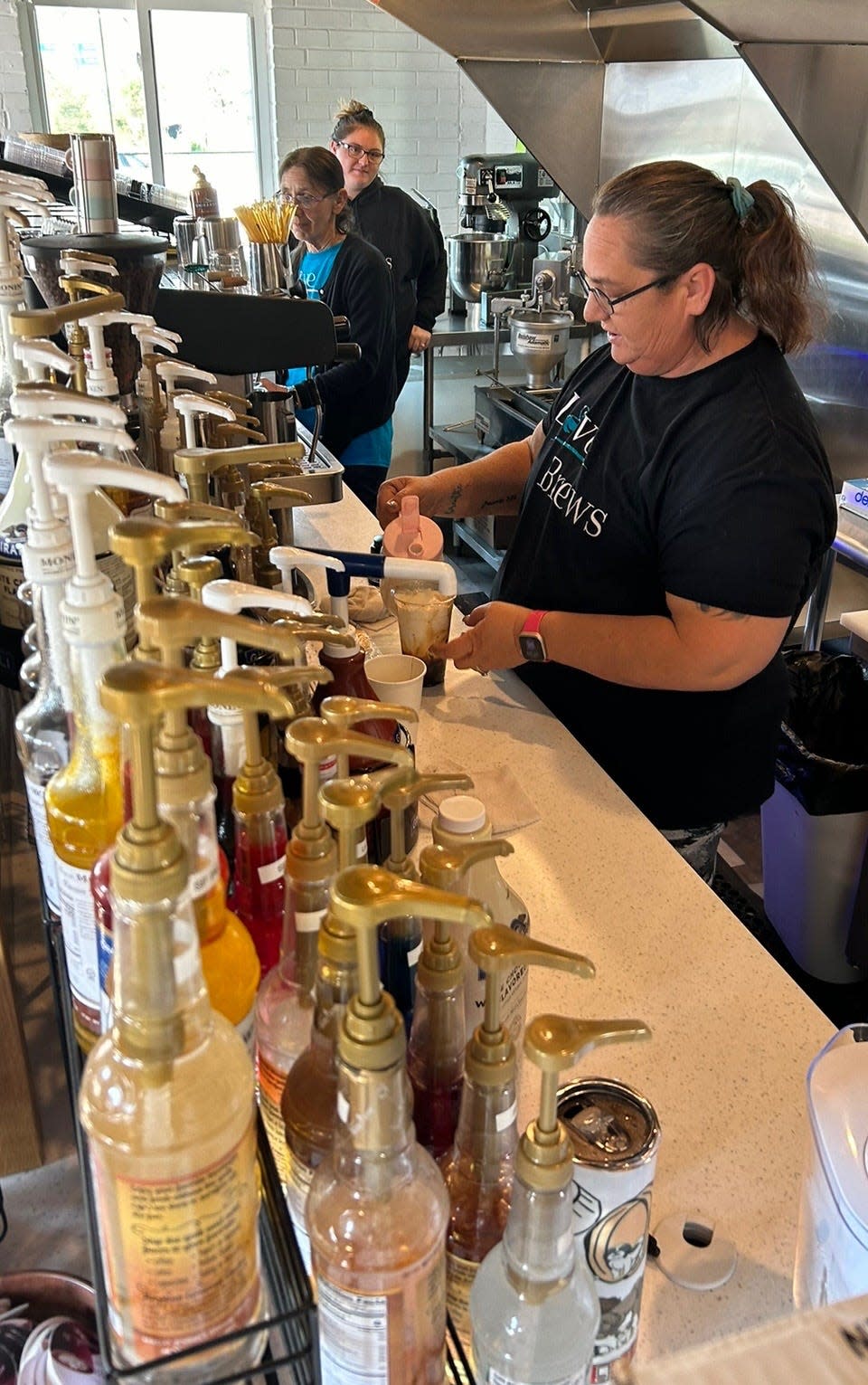 Brandy Sutton mixes up a Noah's Ark specialty iced coffee at Love Brews, a new coffee shop in downtown Louisville.