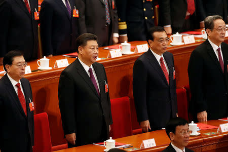 Chinese President Xi Jinping, Chinese Premier Li Keqiang and other officials sing national anthem during the closing session of the National People's Congress (NPC) at the Great Hall of the People in Beijing, China March 20, 2018. REUTERS/Damir Sagolj