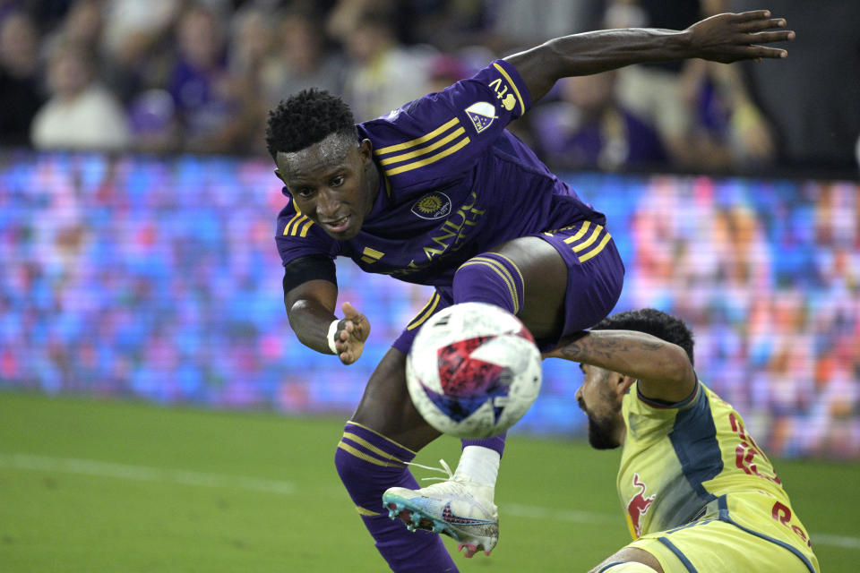 Orlando City forward Ivan Angulo, left, regains control of the ball after New York Red Bulls defender Luquinhas, right, attempted to kick it away during the second half of an MLS soccer match, Saturday, Feb. 25, 2023, in Orlando, Fla. (AP Photo/Phelan M. Ebenhack)