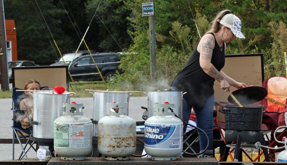 Kimberly “Mama Kim” Usery-Pettis works at her boiled peanut stand Thursday afternoon, Oct. 12, 2023, at the corner of Hickory Grove Road and Woodlawn Street.