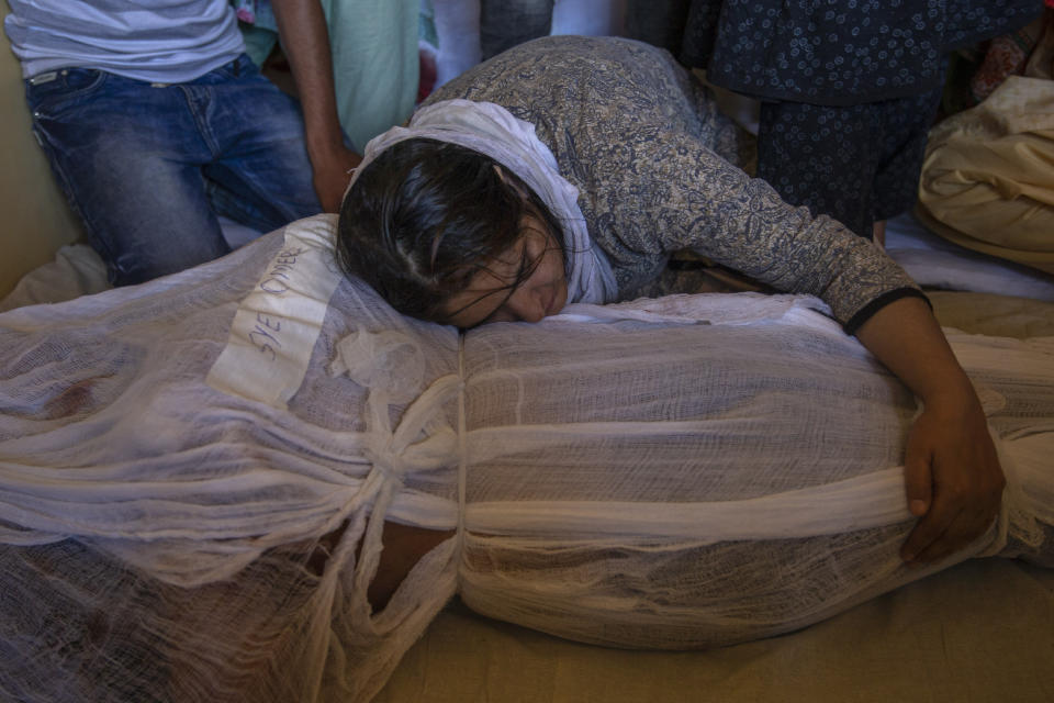 A girl mourns by the body of her brother Syed Omer Bari in Bandipora town, north of Srinagar, Indian controlled Kashmir, Thursday, July 9, 2020. Unidentified assailants late Wednesday fatally shot Sheikh Wasim Bari, a leader with Prime Minister Narendra Modi’s Bharatiya Janata Party, along with his father and brother Syed Omer Bari in Kashmir, police said, in a first major attack against India’s ruling party members in the disputed region. (AP Photo/ Dar Yasin)