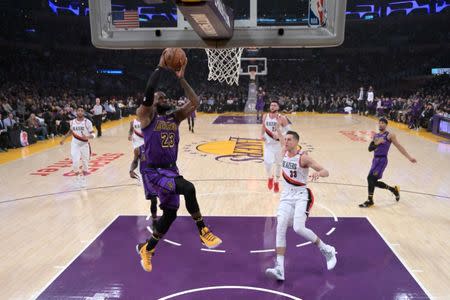 Nov 14, 2018; Los Angeles, CA, USA; Los Angeles Lakers forward LeBron James (23) dunks the ball as Portland Trail Blazers forward Zach Collins (33) defends in the second quarter at Staples Center. Kirby Lee-USA TODAY Sports