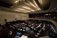 CORRECTS TO SWEARING-IN OF PARLIAMENT, NOT GOVERNMENT - Israeli lawmakers attend the swearing-in ceremony for Israel's parliament, at the Knesset in Jerusalem, Tuesday, Nov. 15, 2022. (AP Photo/ Maya Alleruzzo, Pool)
