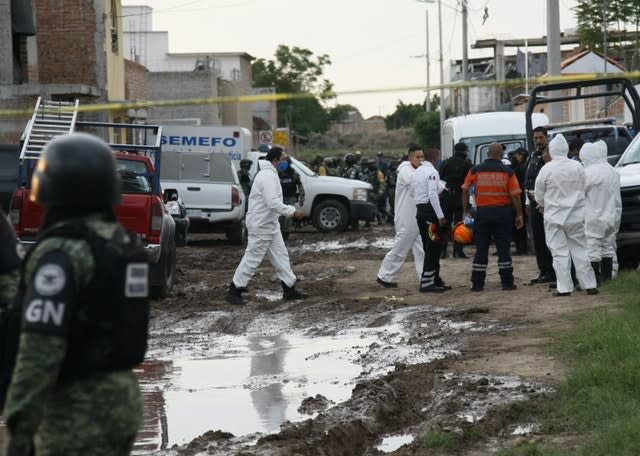 National Guard and forensic investigators at the scene of a mass shooting in Mexico