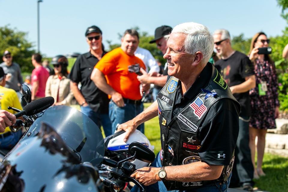 Former Vice President Mike Pence climbs onto his motorcycle during the annual Roast and Ride fundraiser for U.S. Sen. Joni Ernst, Saturday, June 3, 2023, at Big Barn Harley-Davidson in Des Moines, Iowa.