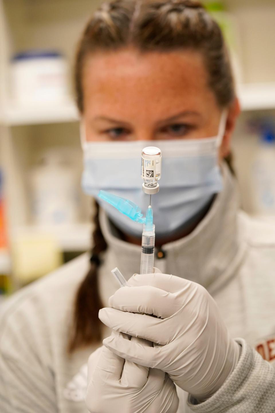 Registered nurse Amy Wells draws a shot of Johnson & Johnson's COVID-19 vaccine in the pharmacy of National Jewish Hospital for distribution early Saturday, March 6, 2021, in east Denver.