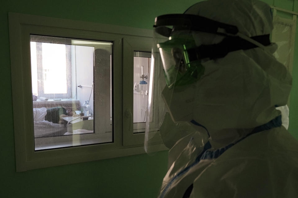 A medical worker walks into a coronavirus ward in a hospital in Sortavala, Karelia region, Russia, Tuesday, Feb. 16, 2021. Russia’s rollout of its coronavirus vaccine is only now picking up speed in some of its more remote regions, although experts say the campaign is still moving slowly. (AP Photo/Dmitri Lovetsky)