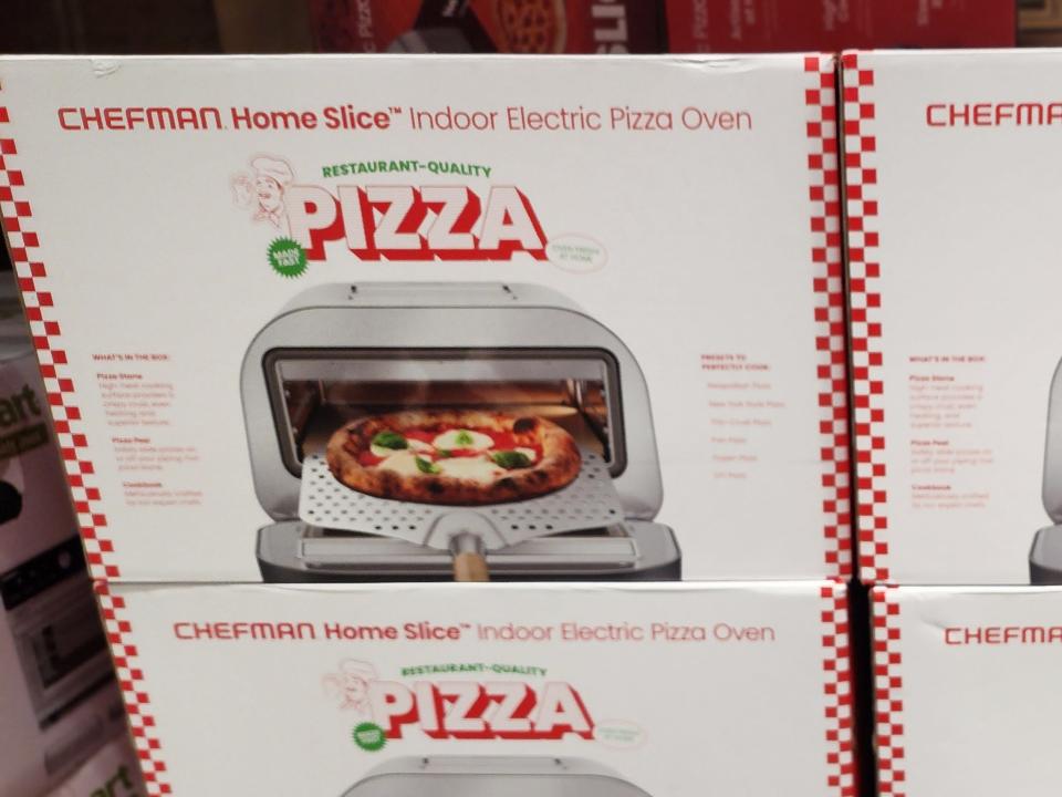 Box of Chefman home slice indoor electric pizza oven depicting pizza going into oven