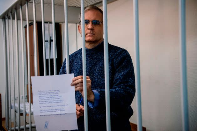 Paul Whelan, a former U.S. Marine accused of espionage in Russia, holds a message as he stands inside a defendants' cage before a hearing to decide to extend his detention at the Lefortovo Court in Moscow, on Oct. 24, 2019. (Photo: Dimitar Dilkoff/AFP via Getty Images)