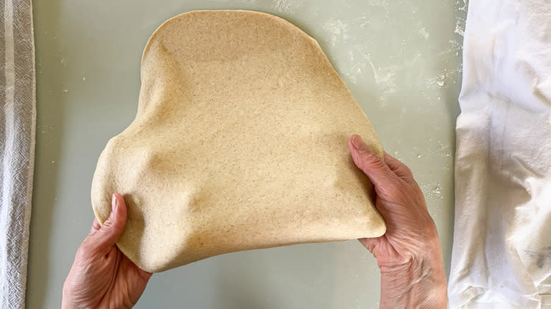 Stretching rye flatbread dough for baking