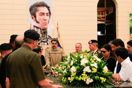 Venezuela's President Nicolas Maduro stands in front of the tomb of Venezuela's late president Hugo Chavez, during a ceremony to commemorate the sixth anniversary of his death at the 4F military fort in Caracas, Venezuela March 5, 2019. Miraflores Palace/Handout via REUTERS