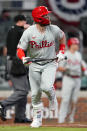 Philadelphia Phillies' Bryce Harper (3) runs to first after hitting a home run in the sixth inning of a baseball game against the Atlanta Braves Sunday, April 11, 2021, in Atlanta. (AP Photo/John Bazemore)