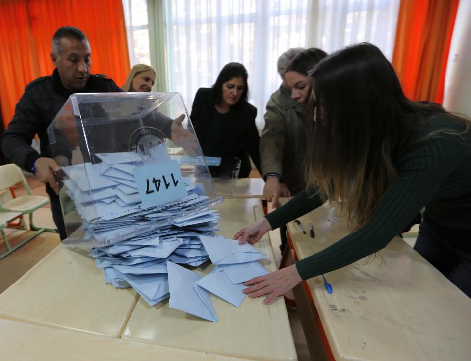 Officials count votes at a polling station in Ankara, Turkey, Sunday, March 30, 2014. Prime Minister Recep Tayyip Erdogan has a central role in Turkey's local elections Sunday even though his name won't be on the ballots. The elections are widely seen as a referendum on Erdogan's tumultuous rule of more than a decade, and the prime minister has been campaigning as if his own career were on the line. High-profile races for mayor of Istanbul and Ankara with incumbents from Erdogan's Justice or Development Party, better known by its Turkish acronym AKP, will be watched closely for signs of whether his influence is waning. The Turkish elections board says more than 50 million people are eligible to vote. (AP Photo/Burhan Ozbilici))