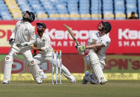 First Test cricket match - Saurashtra Cricket Association Stadium, Rajkot, India - 10/11/16. India's wicketkeeper Wriddhiman Saha (L) and Ajinkya Rahane (C) watch the ball off the bat of England's Ben Stokes. REUTERS/Amit Dave