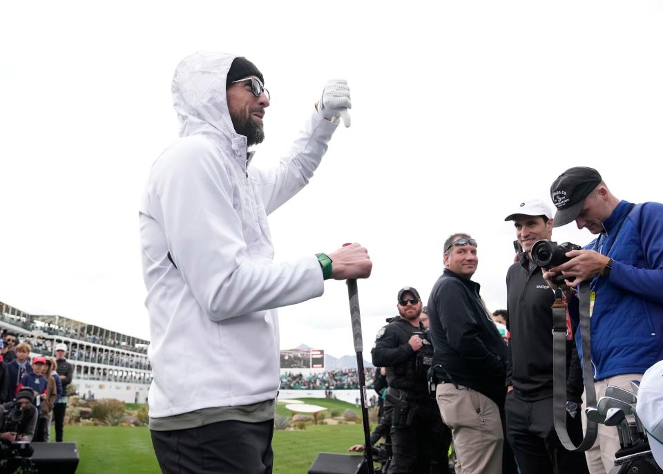 Olympic swimmer Michael Phelps gives his impression of his shot during the WHOOP Shot at Glory on the 16th hole at TPC Scottsdale on Feb. 7, 2024.