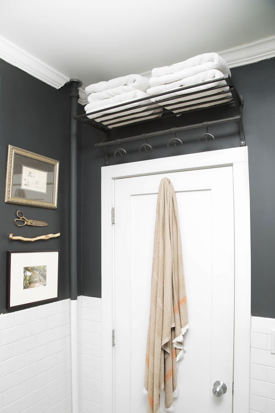 bathroom storage ideas, white towels folded above the white door on shelves