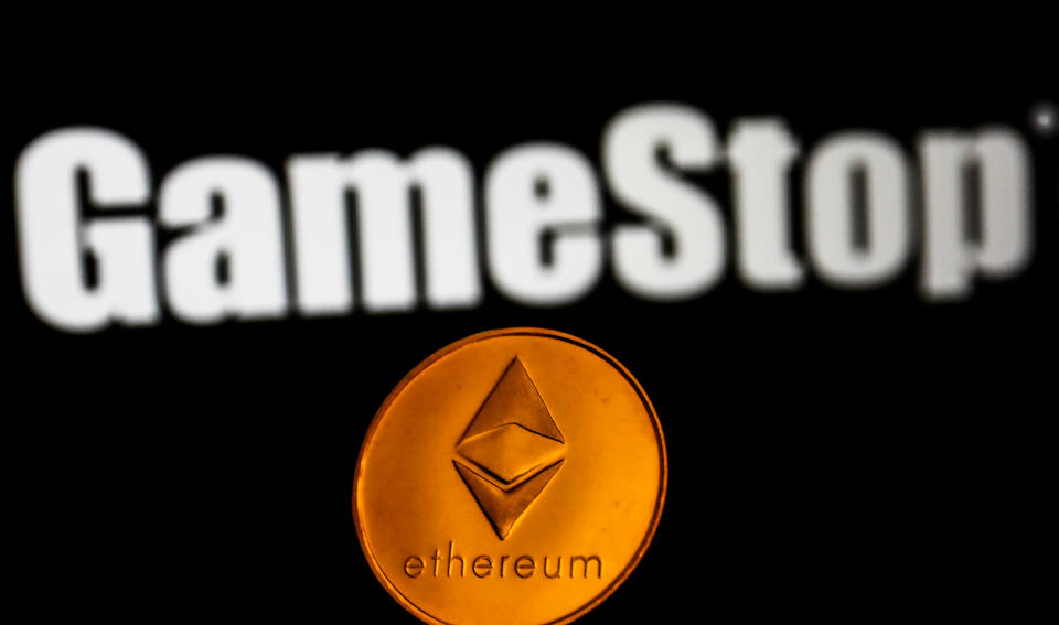 Representation of Ethereum cryptocurrency and GameStop logo displayed on a screen in the background are seen in this illustration photo. (Photo by Jakub Porzycki/NurPhoto via Getty Images)