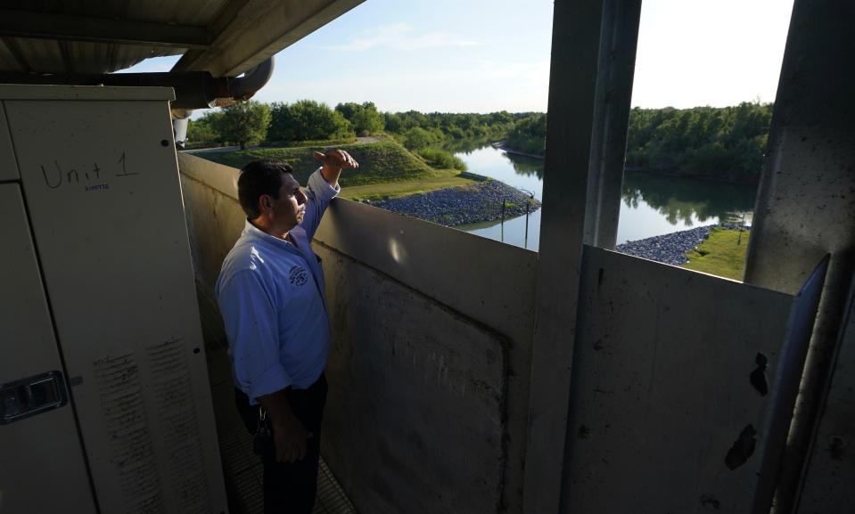 Tomas De Leon, foreman of the Hidalgo County Irrigation District #3 pump station, looks out over a canal that feeds water from the Rio Grande, Tuesday, Sept. 14, 2021, in Hidalgo, Texas. Under a 1944 treaty, Mexico and the U.S. share water from the Rio Grande for use in agriculture, industries and households. Since then, the border cities of McAllen, Brownsville, Reynosa and Matamoros have ballooned — along with their water needs. (AP Photo/Eric Gay)