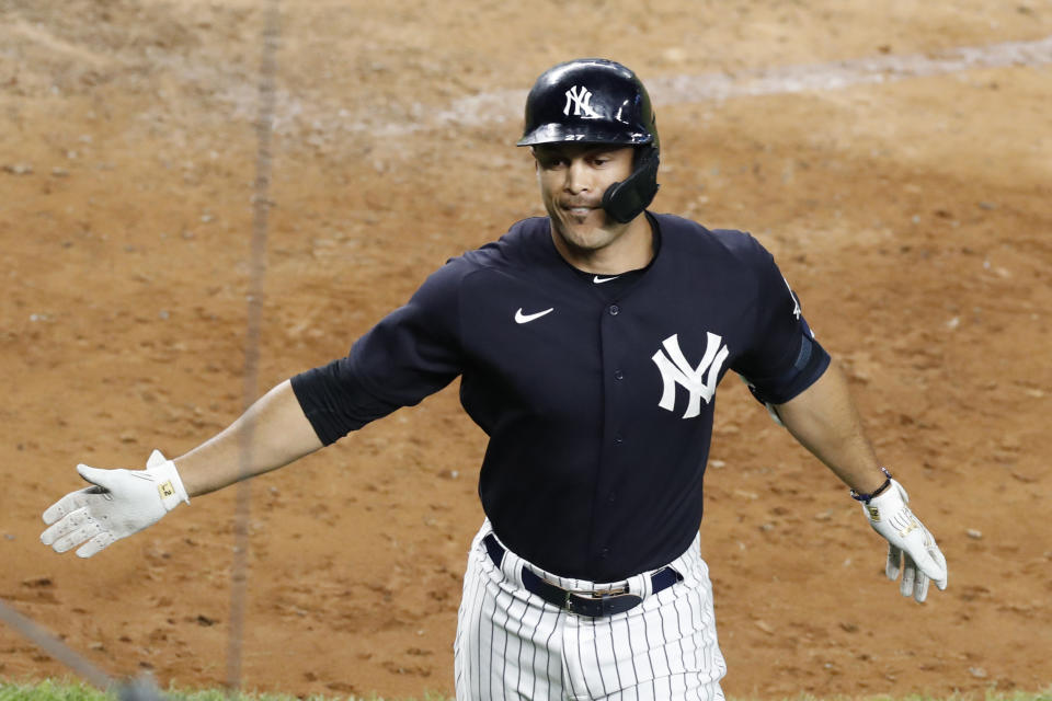 New York Yankees designated hitter Giancarlo Stanton reacts after hitting a seventh inning solo home run in an exhibition baseball game against the New York Mets, Sunday, July 19, 2020, at Yankee Stadium in New York. (AP Photo/Kathy Willens)