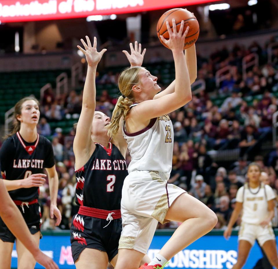 Brandywine junior Miley Young puts up a shot around Lake City junior Hannah Allen during an MHSAA Division 3 girls basketball state semifinal game Thursday, March 21, 2024, at the Breslin Center in East Lansing, Mich.