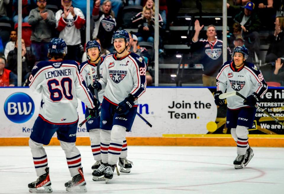 American defenseman Marc Lajoie (28) and forward Elouann Lemonnier (60) celebrate during a game during the 2022-23. Camerin Cardona (88), at right, joins the celebration.