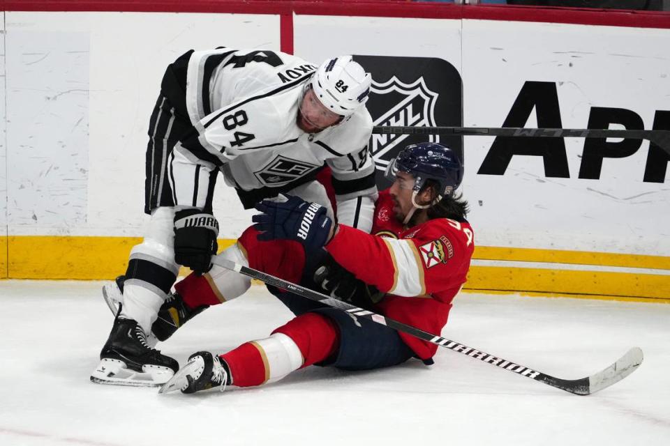 Jan 11, 2024; Sunrise, Florida, USA; Los Angeles Kings defenseman Vladislav Gavrikov (84) holds Florida Panthers left wing Ryan Lomberg (94) on the ice during the first period at Amerant Bank Arena.