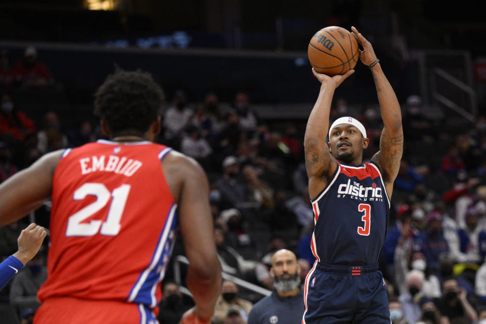 Washington Wizards guard Bradley Beal (3) shoots against Philadelphia 76ers center Joel Embiid (21) during the first half of an NBA basketball game, Monday, Jan. 17, 2022, in Washington. (AP Photo/Nick Wass)