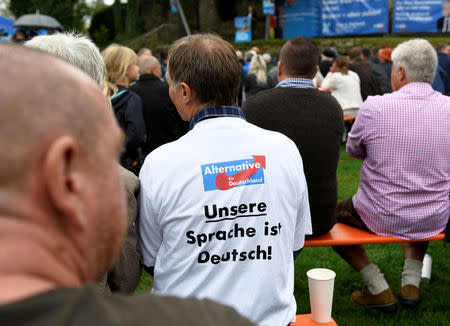 FILE PHOTO: A supporter of Germany's anti-immigration party Alternative for Germany (AfD) wearing a t-shirt that reads 'Our language is German' attends the traditional Gillamoos festival in Abensberg, Germany, September 3, 2018. REUTERS/Andreas Gebert/File Photo