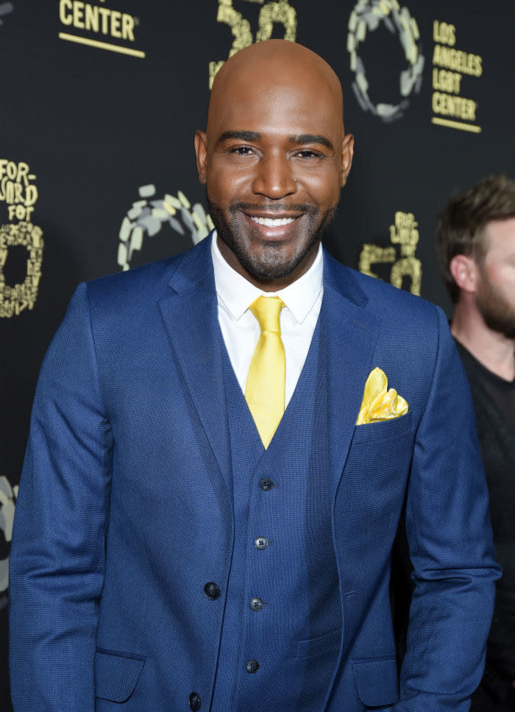 Karamo smiling at an event