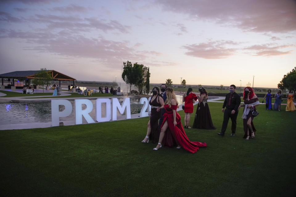 Young people attend prom at the Grace Gardens Event Center in El Paso, Texas on Friday, May 7, 2021. Around 2,000 attended the outdoor event at the private venue after local school districts announced they would not host proms this year. Tickets cost $45. (AP Photo/Paul Ratje)