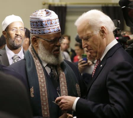 United States Vice President Joe Biden (R) greets Imam Sheikh Sa'ad Musse Roble of Minneapolis, Minnesota during a roundtable on countering violent extremism at the White House in Washington February 17, 2015. REUTERS/Gary Cameron