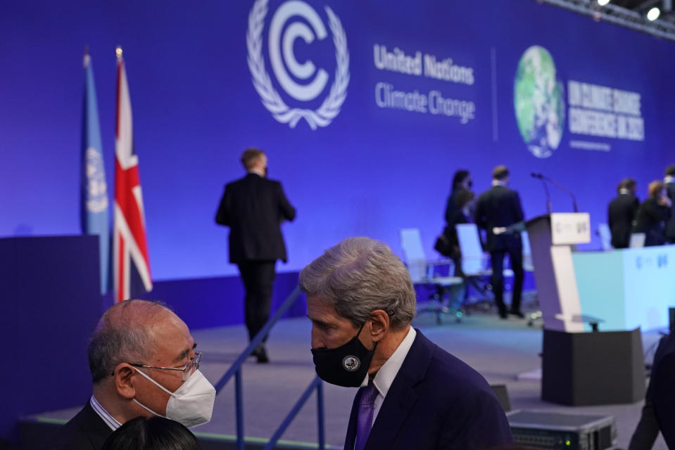 FILE - China's chief negotiator Xie Zhenhua, left, talks with John Kerry, United States Special Presidential Envoy for Climate, right, during a stocktaking plenary session at the COP26 U.N. Climate Summit in Glasgow, Scotland, Nov. 13, 2021. (AP Photo/Alberto Pezzali, File)