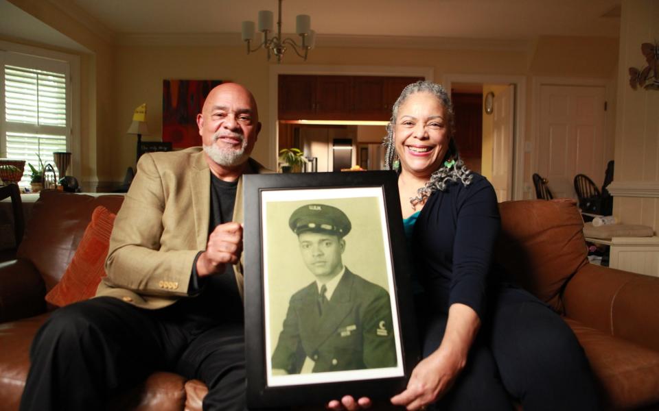 Frank Bland and his wife Irene Bland hold a portrait of Frank's father, George Bland, one of the soldier's featured in the new series