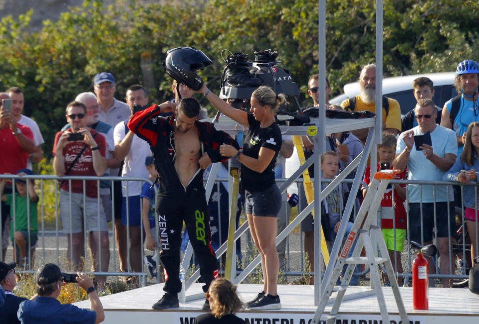 Franky Zapata, a 40-year-old inventor, prepares for take-off in Sangatte, Northern France, at the start of his attempt to cross the channel from France to England, aboard his flyboard Thursday July 25, 2019. Zapata is anchored to his flyboard, a small flying platform he invented, taking off from Sangatte, in France's Pas de Calais region, and flying to the Dover area in southeast England. (AP Photo/Michel Spingler)