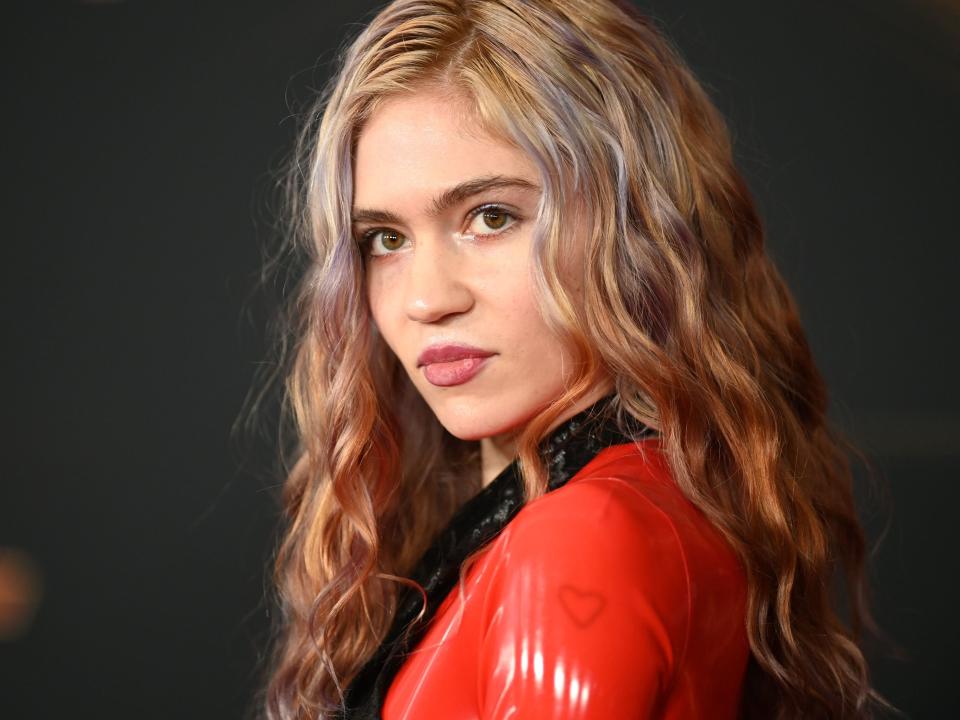 Photo of Grimes wearing a red costume